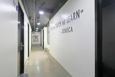 a hallway of an art gallery with a sign on the wall at Spot On Classy Bunkbeds Near Makati Manila Formerly MYTOWN Madrid in Manila