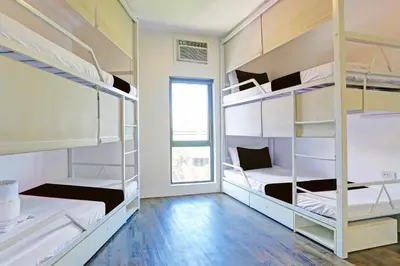 a room with four bunk beds and a window at Spot On Hostel ,Taguig Manila Formerly MYTOWN HongKong in Manila