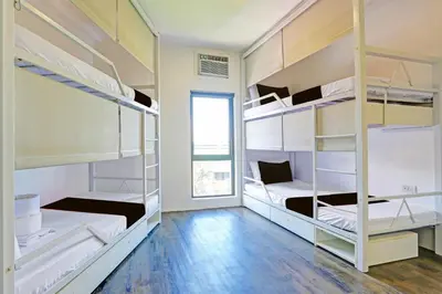 a room with four bunk beds with a window at Spot On Hostel ,Taguig Manila Formerly MYTOWN HongKong in Manila