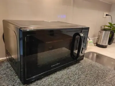 a microwave sitting on top of a kitchen counter at 1BR Condotel Ridgewood Towers Taguig City #RW05 in Manila