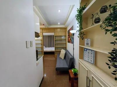 a room with a hallway with a room with a bed at 1BR Condotel Ridgewood Towers Taguig City #RW05 in Manila