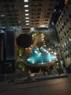 an overhead view of a city at night with a pool at 1BR Condotel Ridgewood Towers Taguig City #RW07 in Manila