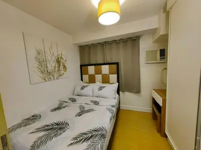 a small bedroom with a bed in a room at 1BR Condotel Ridgewood Towers Taguig City #RW08 in Manila