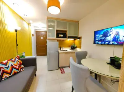 a kitchen with a couch and a table in a room at 1BR Condotel Ridgewood Towers Taguig City #RW08 in Manila