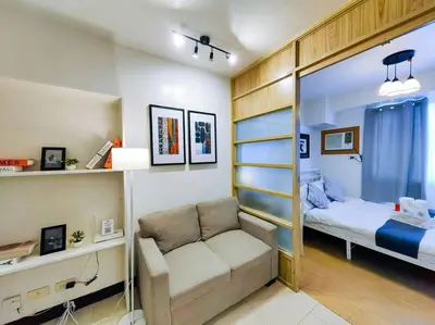a small room with a bed and a couch in it at 1BR Condotel Ridgewood Towers Taguig City #RW09 in Manila