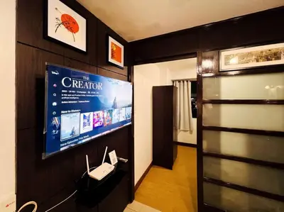 a room with a tv and a phone on a wall at 1BR Condotel Ridgewood Towers Taguig City #RW12 in Manila