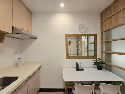 a white kitchen with a sink and a mirror at 1BR Condotel Ridgewood Towers Taguig City #RW13 in Manila