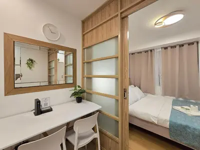 a small bedroom with a bed and a mirror at 1BR Condotel Ridgewood Towers Taguig City #RW13 in Manila