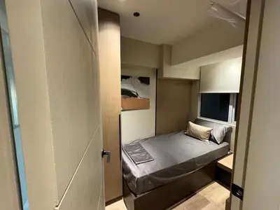 a small bedroom with a bed in a small room at Dazzling fully furnished unit BGC w Pool in Manila