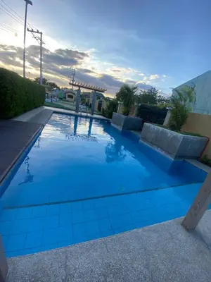 a swimming pool with blue tiles on the ground at Kral Suite in Las Piñas in Manila