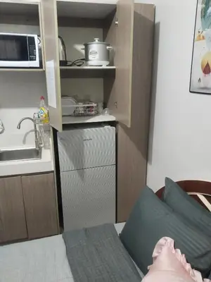 a small kitchen with a sink and a kitchen at Nice condotel in Manila
