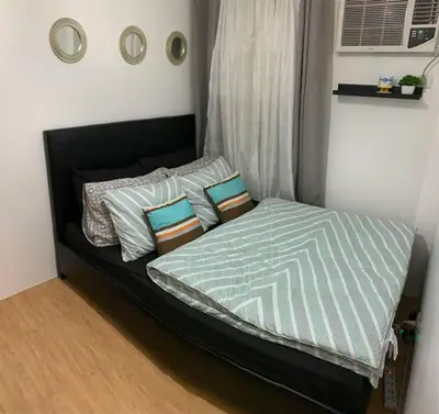 a bed with pillows on it in a bedroom at Condo In Manila in Manila