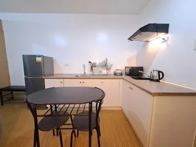 a small kitchen with a table and two chairs at Grace Tower 3 in Manila