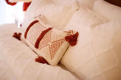 a white pillow sitting on top of a bed at Luxury Oasis in Makati with Balcony in Manila