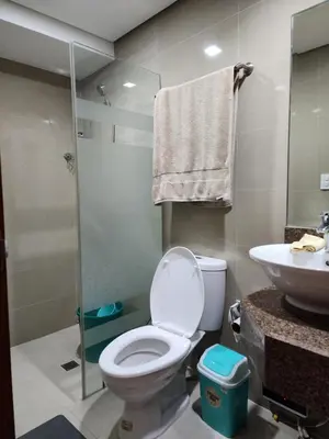 a bathroom with a toilet and a sink and a shower at Eastwood LeGrand 3 Eastwood City, Quezon City in Manila