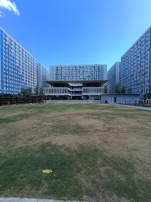 a large building with a large field in front of it at SleepScape Staycation in Manila