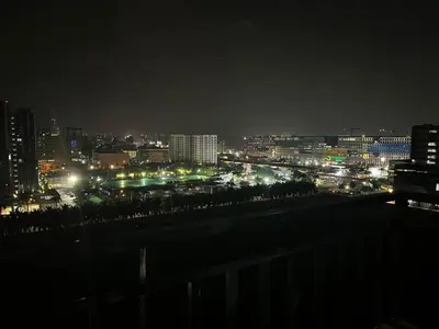 a view of a city at night with lights at Oranje Suite near NAIA AIRPORT in Manila