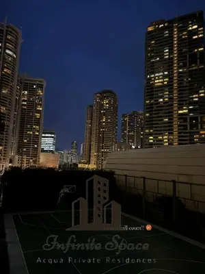 a city skyline at night with tall buildings at Infinite Space at Acqua Private Residences - Iguazu Tower in Manila