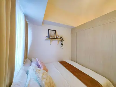 a bed in a room with a window at 1BR Condotel with Balcony at SM Light Residences #LT02 in Manila