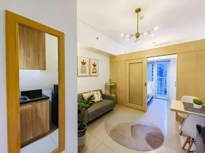 a living room with a couch and a table at 1BR Condotel with Balcony at SM Light Residences #LT03 in Manila