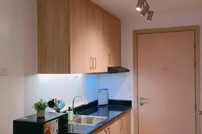 a kitchen with a sink and a counter top at 1BR Condotel with Balcony at SM Light Residences #LT04 in Manila