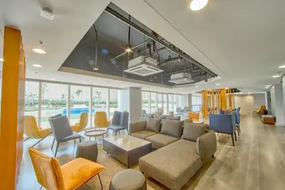 a living room with a couch and chairs at The Connor Serviced Residences Managed by HII in Manila