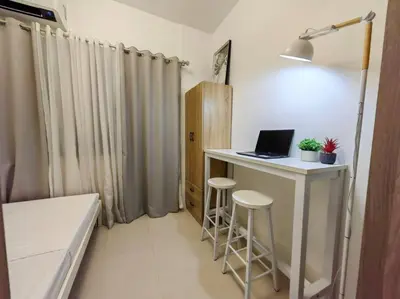 a small room with a desk with a laptop on it at 1BR Condotel with Balcony at FAME Residences #FM01 in Manila