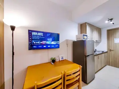a kitchen with a yellow table and a refrigerator at 1BR Condotel with Balcony at FAME Residences #FM02 in Manila