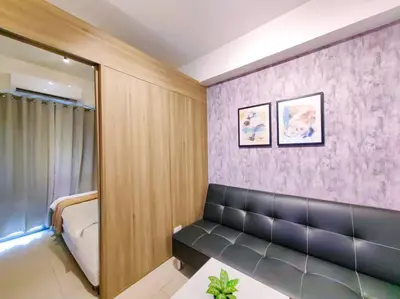a room with a couch and a mirror at 1BR Condotel with Balcony at FAME Residences #FM03 in Manila