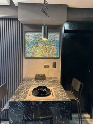 a kitchen with a counter top with a table and chairs at Casa Rica for adventurous fun - C Fort TB in Manila