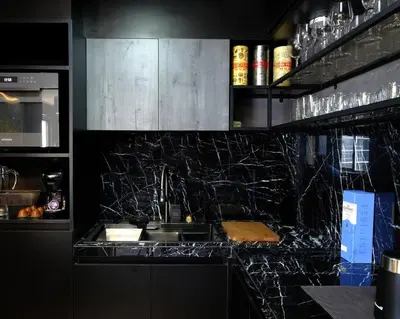 a kitchen with black granite counter tops and a sink at Casa Rica for adventurous fun - C Fort TB in Manila