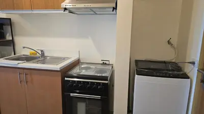 a small kitchen with a stove and a sink at 8 Adriatico Condotel Unit Facing Manila Bay in Manila