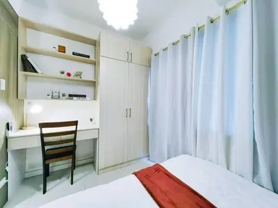 a bedroom with a bed and a desk and a chair at 1BR Condotel with Balcony at FAME Residences #FM06 in Manila