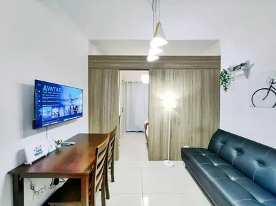 a living room with a blue couch and a table at 1BR Condotel with Balcony at FAME Residences #FM06 in Manila