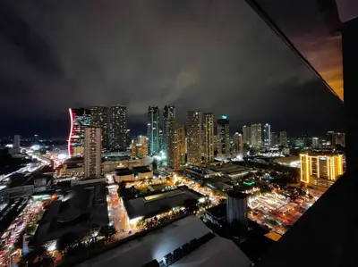 a view of a city at night with lights at 1BR Condotel with Balcony at FAME Residences #FM07 in Manila