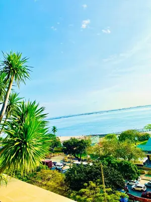 a view of a beach with palm trees and the ocean at Serene Condo Unit in Front of US Embassy in Manila