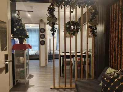 a living room with a dining room table with christmas decorations at Deca Suites 946 in Manila