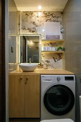 a bathroom with a sink and a washing machine at Air Residences, SMDC, Makati in Manila
