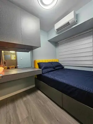 a bedroom with a blue bed and a mirror at S Residences Luxury Unit in Manila