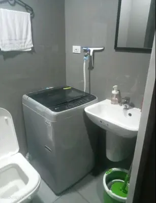 a small bathroom with a sink and a toilet at FCMCO Condotel in Manila