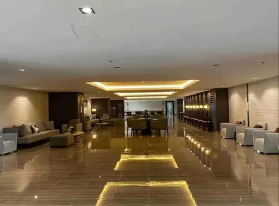a lobby of a hotel with couches and tables at FCMCO Condotel in Manila