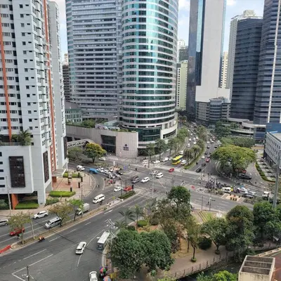 a busy city street with traffic in a city with tall buildings at FCMCO Condotel in Manila