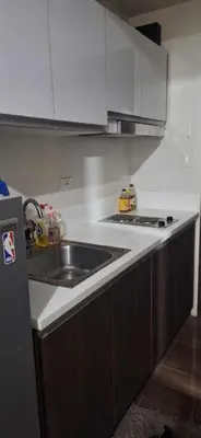 a kitchen with a sink and a stove at FCMCO Condotel in Manila