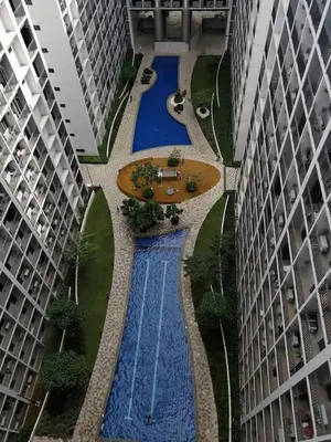 an overhead view of a swimming pool between two buildings at Humpreys Comforts in Manila