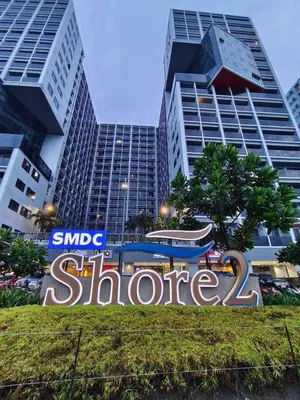 a sign in front of a building with tall buildings at Humpreys Comforts in Manila