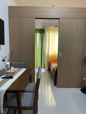 a room with a dining table and a bed at Lush Residences Makati City by darpm in Manila
