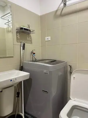 a small bathroom with a sink and a toilet at Lush Residences Makati City by darpm in Manila