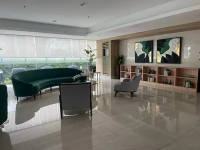 a living room with a green couch and chairs at Lush Residences Makati City by darpm in Manila
