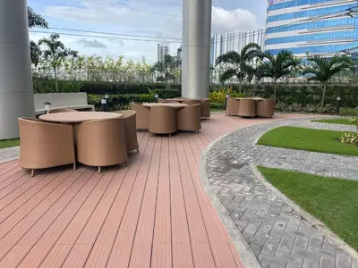 a row of tables and chairs on a patio at Lush Residences Makati City by darpm in Manila