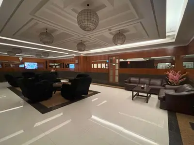 a lobby with couches and chairs and a table at Lido De Paris Hotel in Manila